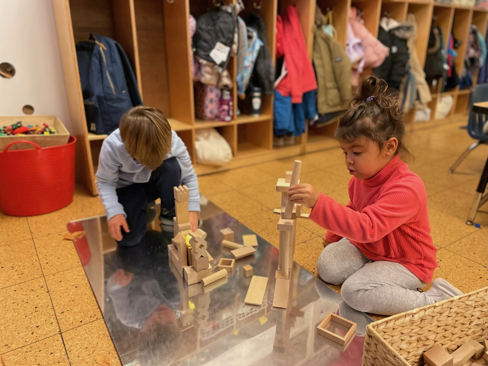 Child stacking wooden blocks