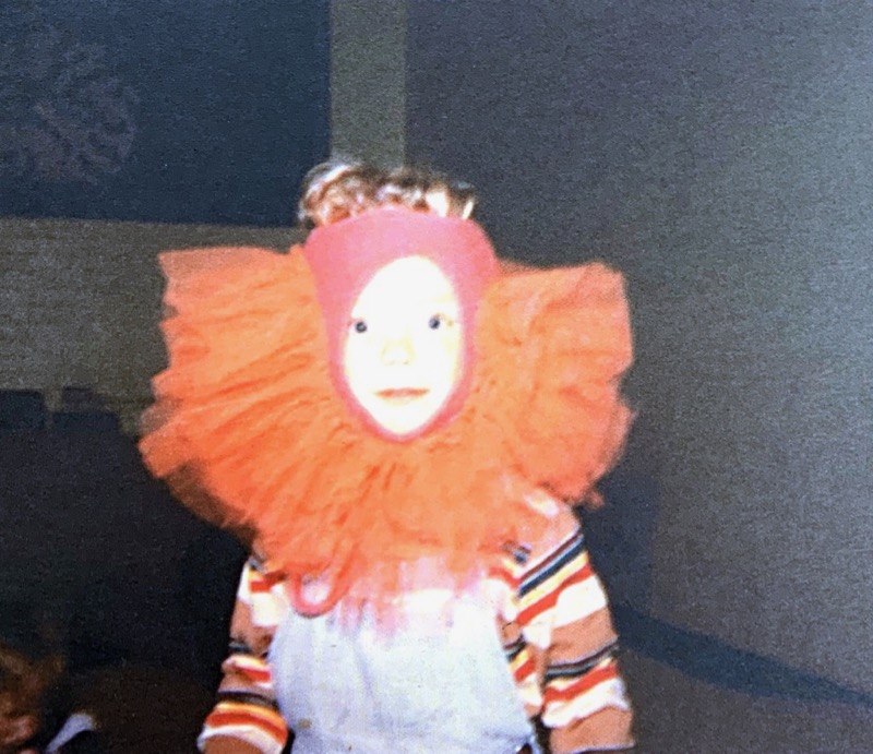 child with tutu on head