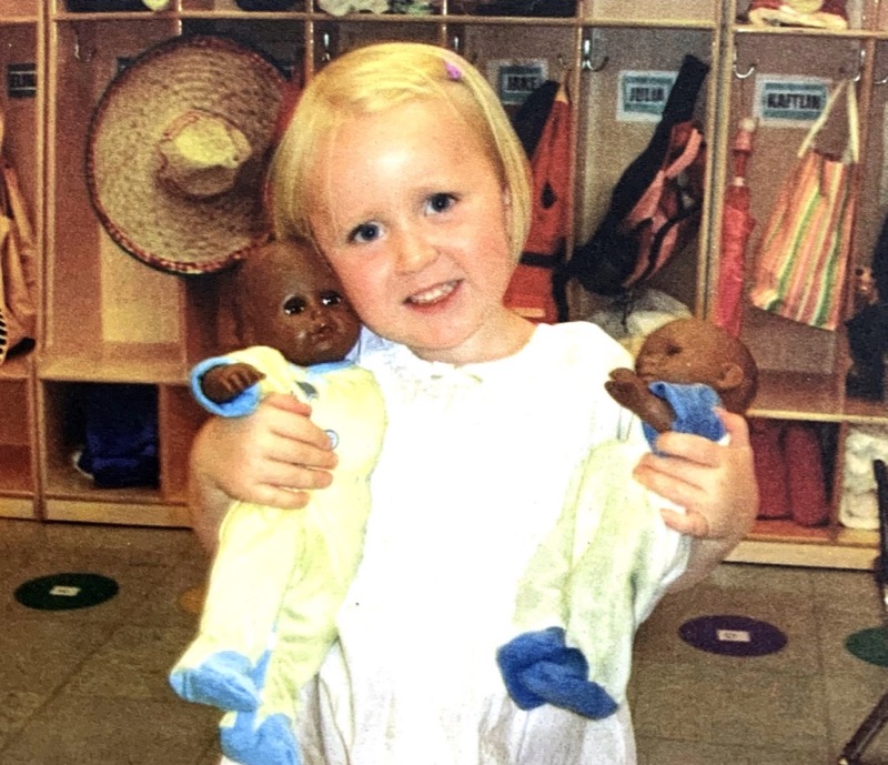 child holding dolls