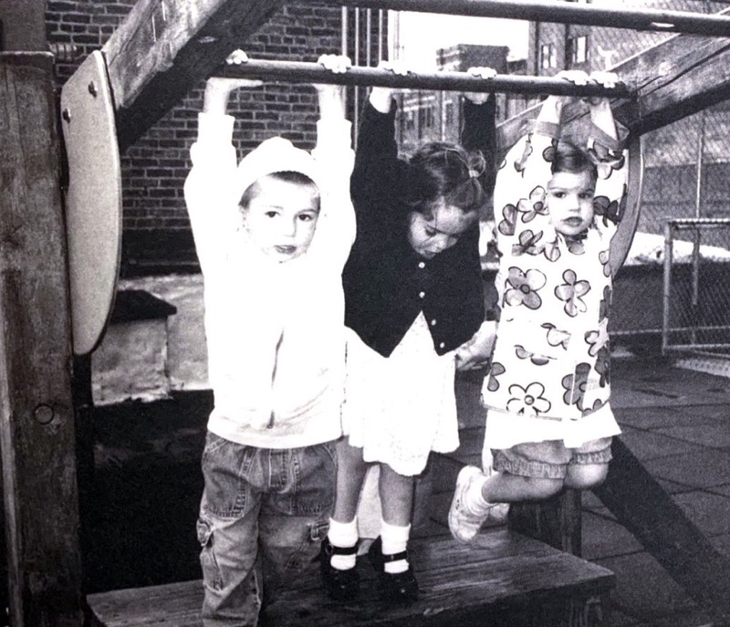 three children swinging on playground
