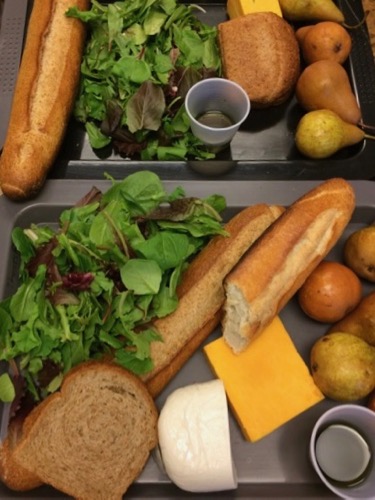 bread cheese and salad on a tray