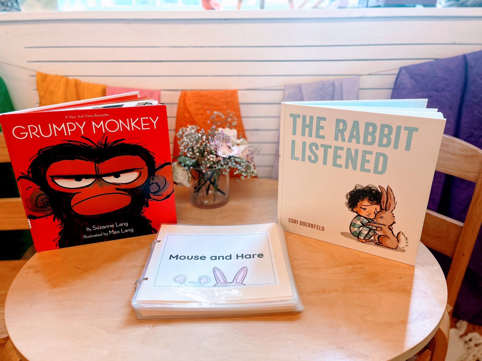 Three children's books on a table