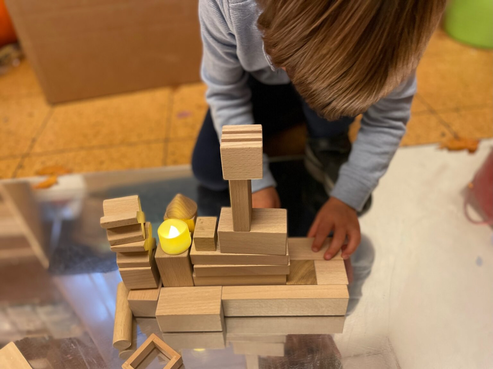 Child playing with wooden rings