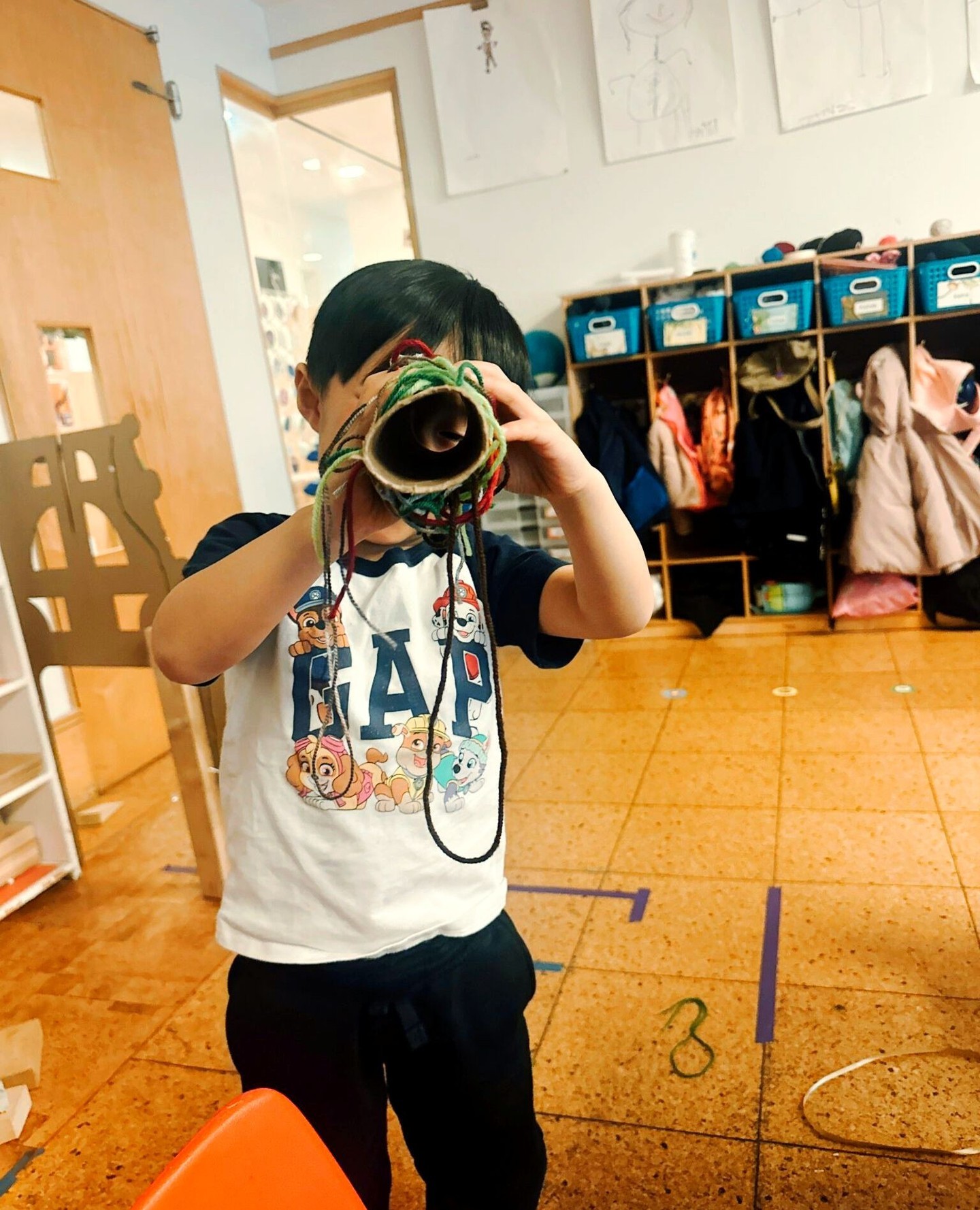 child looking through a tube into the future