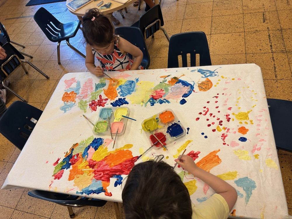 children painting at a table